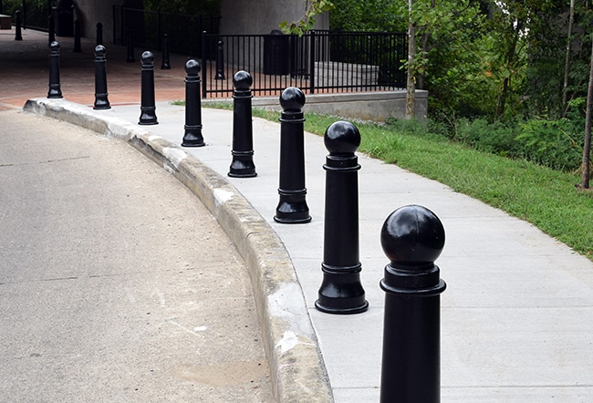 Several bollards by a sidewalk