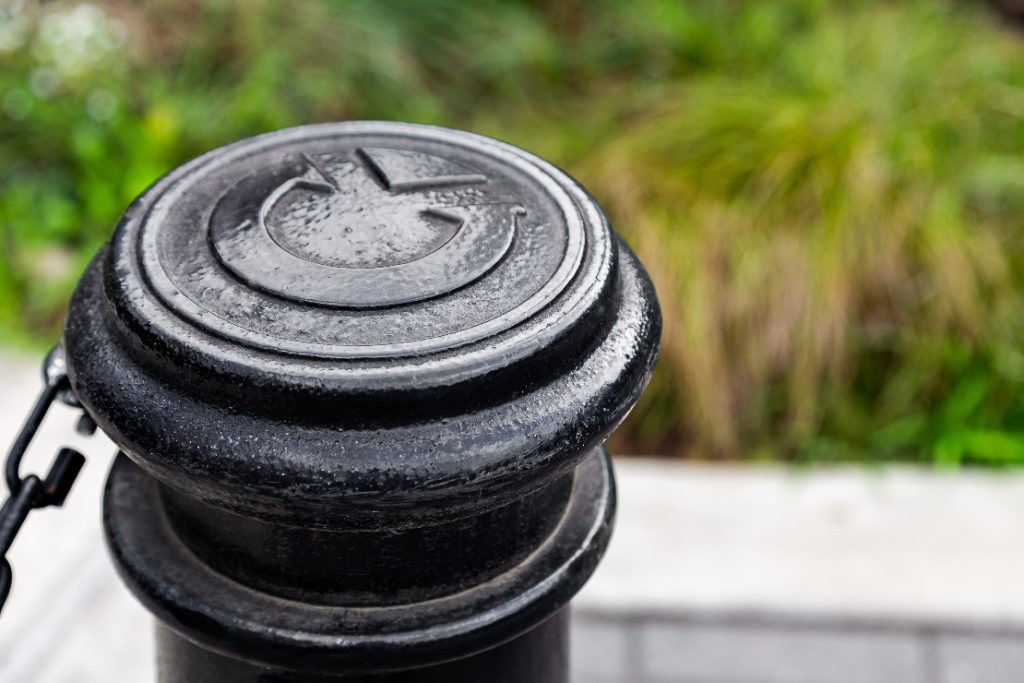 A bollard top with a custom stamped logo.