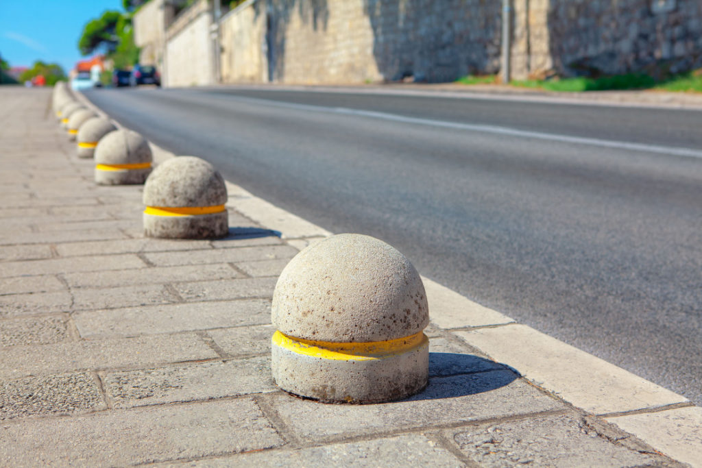Unsightly concrete bollards on a roadside.