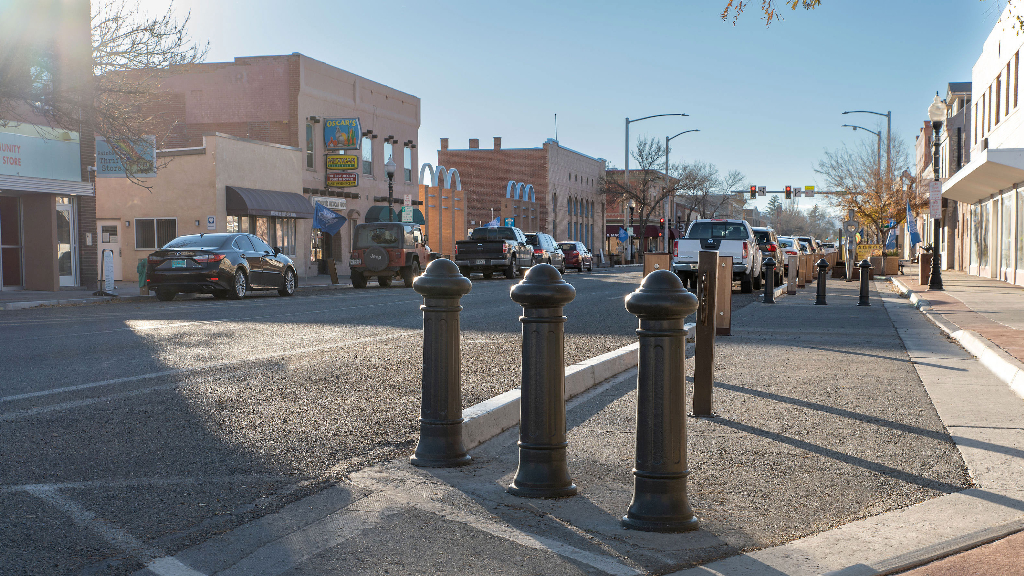 Three bollards guard access to a biking and pedestrian lane in Alamosa, Colorado.