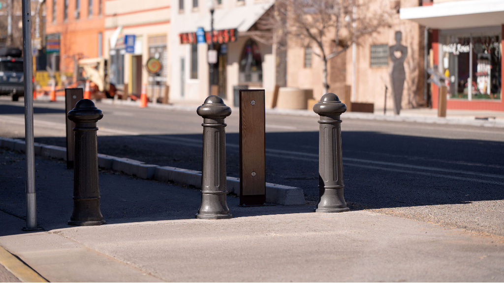 Bollards, wooden posts and concrete curbing define a biking and pedestrian lane in downtown Alamosa, Colorado.