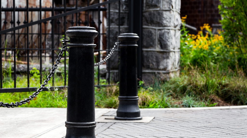Black cast iron removable bollards outside the entry to a venue.